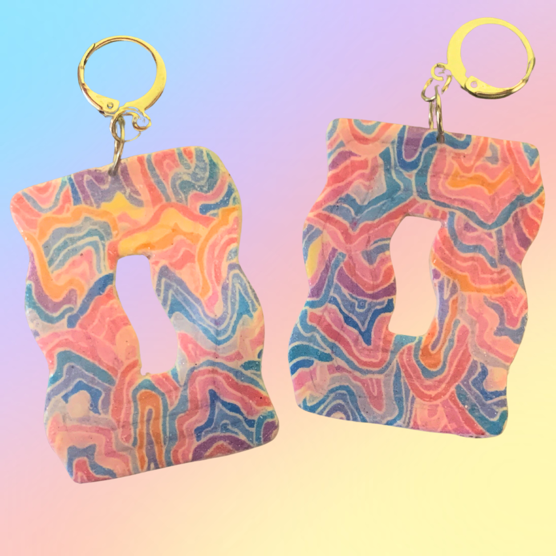 Abstract Wavy Dangles - Studio Mintii Get ready to add a pop of colour to your outfit with our Abstract Wavy Dangles! Made from polymer clay, these playful earrings feature abstract wavy designs and a fun rainbow colour scheme. Perfect for adding a touch of quirkiness to your style.  #