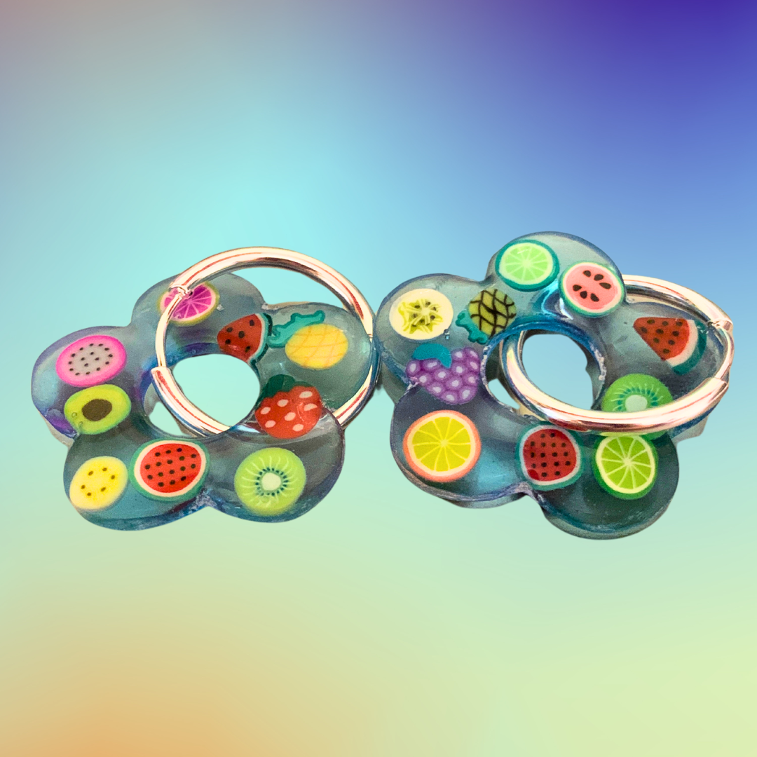 Blue Fruit Jelly Flower Hoops - Studio Mintii Add a fun and fruity touch to your jewellery collection with our Blue Fruit Jelly Flower Hoops! These unique earrings are made from resin and polymer clay fruit slices, adding a playful and colourful touch to any outfit. Bring a slice of fun into your style with these earrings.  #