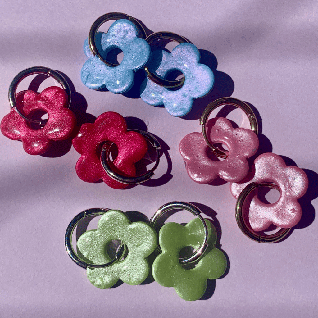 Small Flower Hoops - Studio Mintii Add a little sparkle to your look with our Small Flower Hoops! These glittery floral hoops are handcrafted from polymer clay and coated with resin for a glossy finish. Perfect for adding a touch of whimsy to any outfit. (Get ready for compliments!) Currently available in green, red, pink, and blue. You can choose either gold or silver hoops.  #