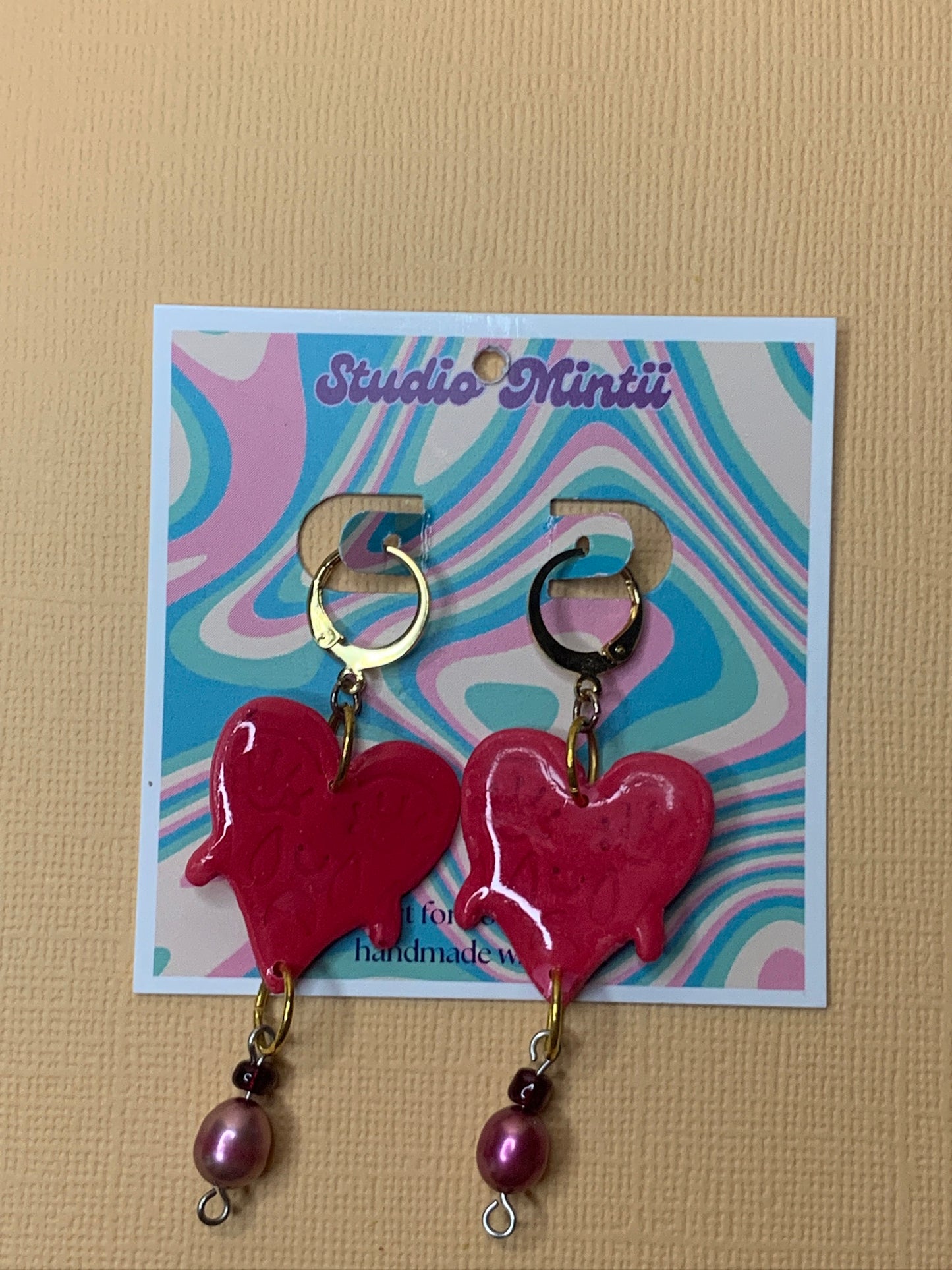 Crying Heart Dangles - Studio Mintii These Crying Heart Dangles will tug at your heartstrings (and earlobes). The red glass, and pearl beads add a touch of elegance to these quirky and playful earrings.  #