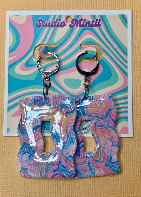 Abstract Wavy Dangles - Studio Mintii Get ready to add a pop of colour to your outfit with our Abstract Wavy Dangles! Made from polymer clay, these playful earrings feature abstract wavy designs and a fun rainbow colour scheme. Perfect for adding a touch of quirkiness to your style.  #