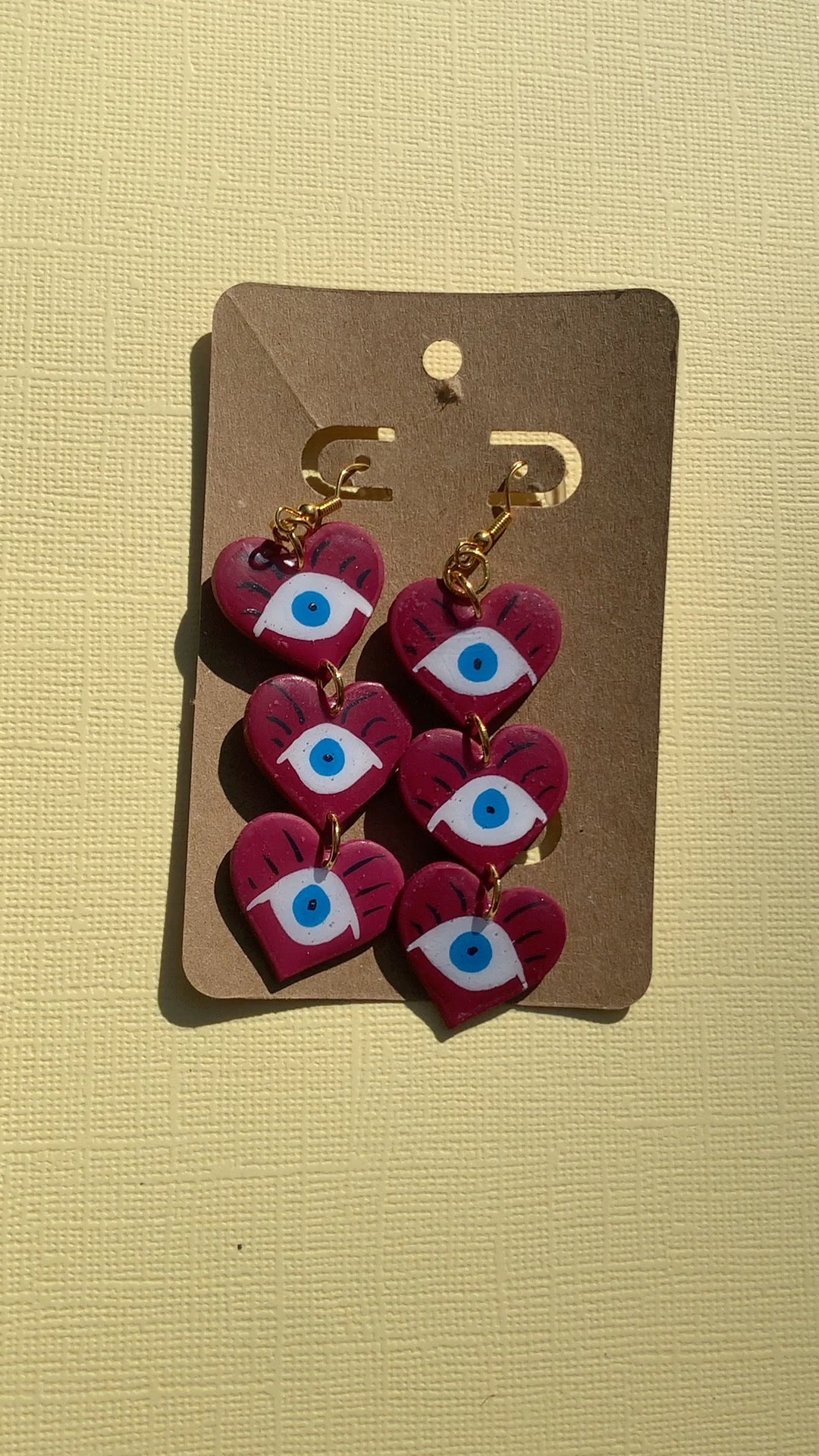 Evil Eye Drop Trio - Studio Mintii Keep bad vibes away with our Evil Eye Drop Trio! These quirky dangle earrings are handmade from polymer clay and resin, ensuring quality and durability. Make a statement and protect yourself at the same time - talk about killing two birds with one stone! Note: I played around to get this purple colour. For future stock, these will be made in a red colour scheme.  #