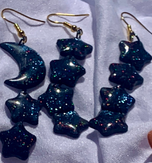 Glittery Cascading Star Dangles - Studio Mintii Twinkle and shine with these Glittery Cascading Star Dangles! Perfect for adding a touch of sparkle to any outfit, these earrings feature cascading stars that catch the light with every move. A playful and eye-catching addition to your accessory collection.  #