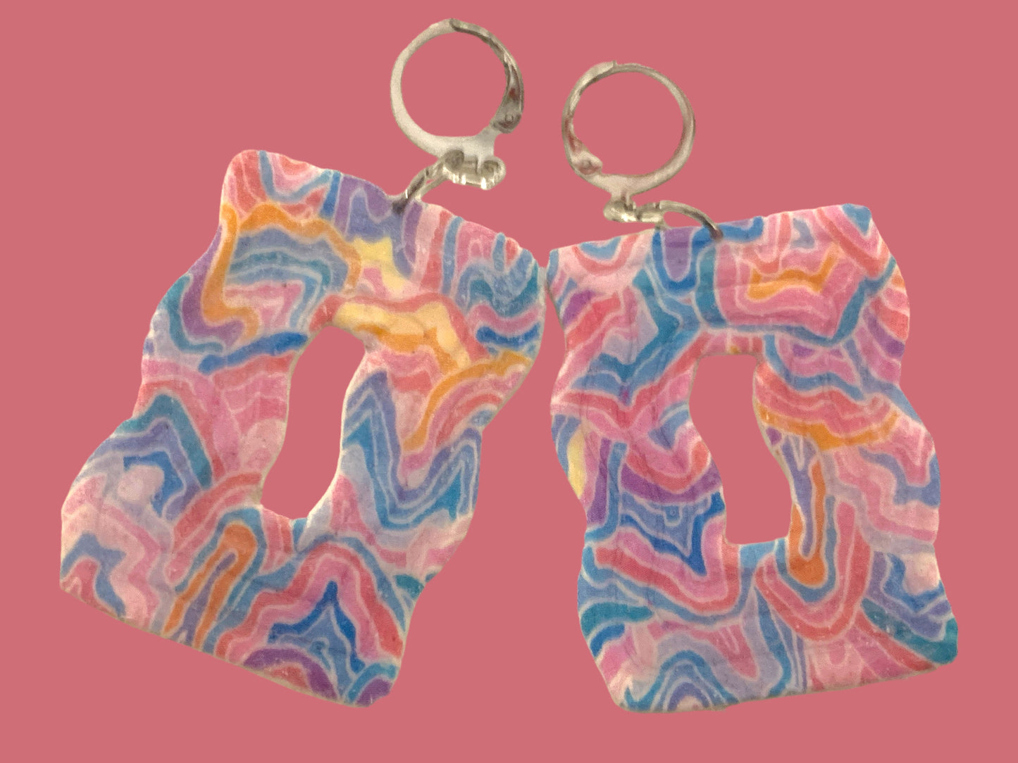 Abstract Wavy Dangles - Studio Mintii Get ready to add a pop of colour to your outfit with our Abstract Wavy Dangles! Made from polymer clay, these playful earrings feature abstract wavy designs and a fun rainbow colour scheme. Perfect for adding a touch of quirkiness to your style.  #